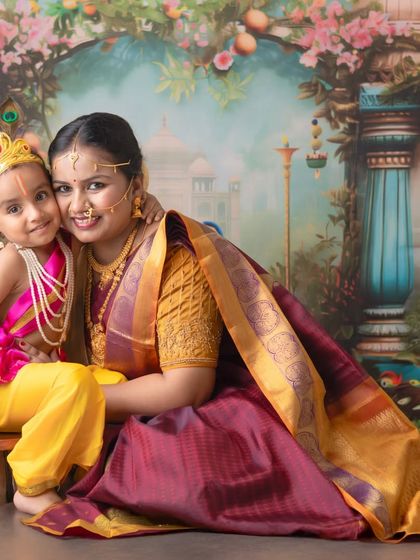 A tender embrace between Yashoda and her mischievous Kanha. This close-up portrait highlights the emotional connection and the intricate details of the traditional attire and jewelry.