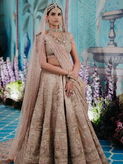 This is what bridal dreams are made of. For bride Manisha, we found this breathtaking Tarun Tahiliani lehenga that felt like it was made just for her. The look is completed with layered necklaces, a delicate matha patti, and a nath for that perfect, timeless pheras look.