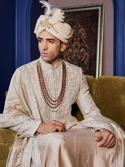 A closer portrait allows you to appreciate the detailed embroidery on the sherwani and the craftsmanship of the turban and jewelry.