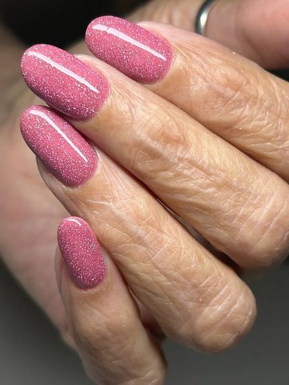 A shimmery, rose-gold pink manicure. This warm, sparkling shade is both glamorous and feminine.