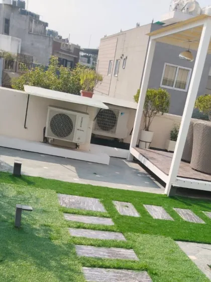A terrace doesn't have to be just a boring concrete slab. For this Delhi rooftop, I created a beautiful garden look by combining lush artificial grass with stone slab pathways, turning it into a functional and stylish space.