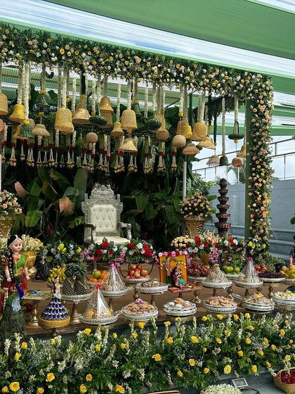 A wide view of a stage with a canopy of hanging yellow floral bells.