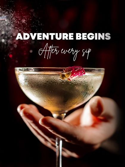 Adventure begins after every sip. This image of a hand holding a delicate, sparkling cocktail suggests that our drinks are the start of a magical journey.