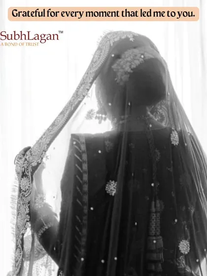 A black and white portrait of a bride, her face covered by an intricately embroidered dupatta. This artistic shot captures the mystery and grace of a bride on her wedding day.