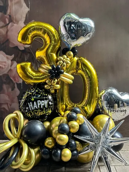 Turning 30 is a major milestone, and we marked the occasion with this bold black and gold number bouquet. Combining large foil numbers with a dynamic arrangement of chrome, black, and starburst balloons, this piece makes a powerful statement. It's perfect for creating an unforgettable photo opportunity.