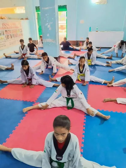 A class full of students working on their middle splits. We dedicate a part of every class to improving flexibility.