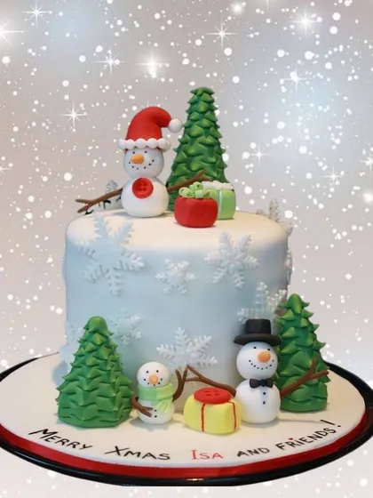 A whimsical winter scene for Isa and friends. This Christmas cake is decorated with cute fondant snowmen, Christmas trees, and a dusting of snow.