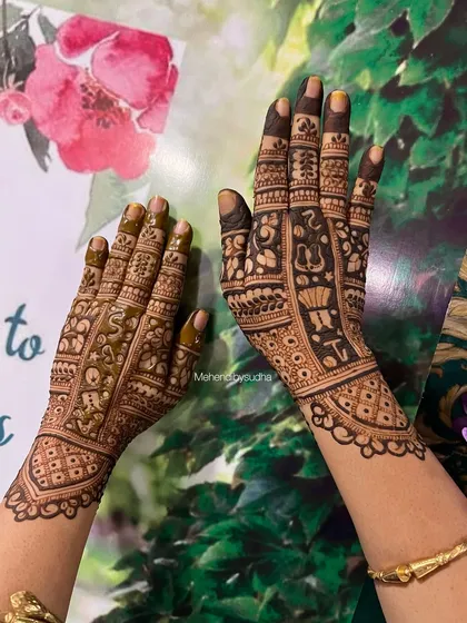 This baby shower mehendi is filled with cute elements like baby clothes, shoes, and toys. It's a playful and detailed design perfect for a mom-to-be.