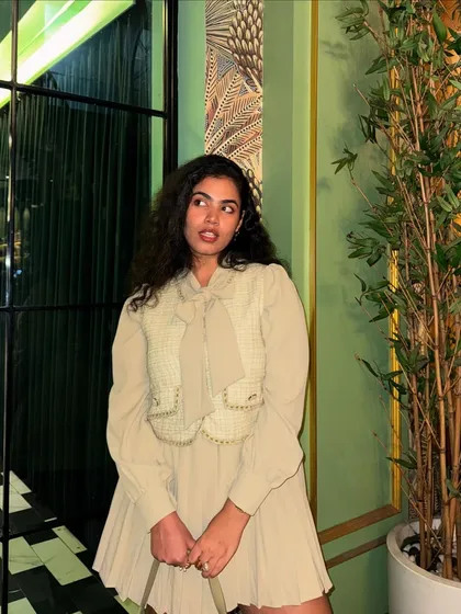 Another look at the dinner outfit against a gorgeous green backdrop. The neutral tones of my outfit really pop against the rich color.