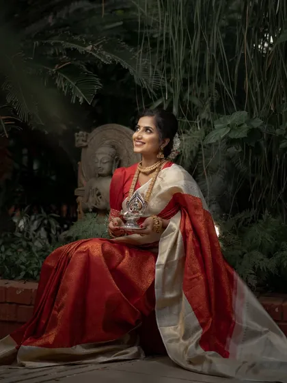 The serene expression and traditional attire create a powerful image of bridal elegance. This Kanchipuram silk is an heirloom in the making.