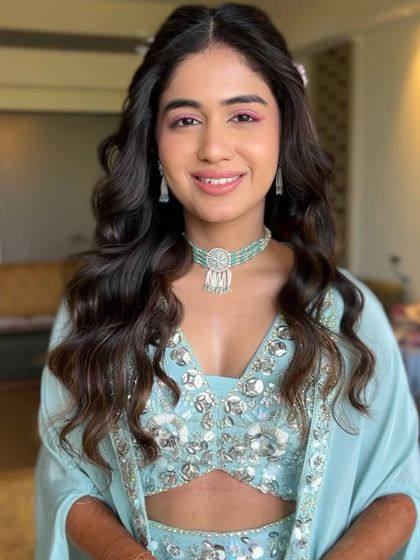 My bride Serena in her Haldi glow. We added a pop of pink on the eyes to complement her beautiful light blue outfit.