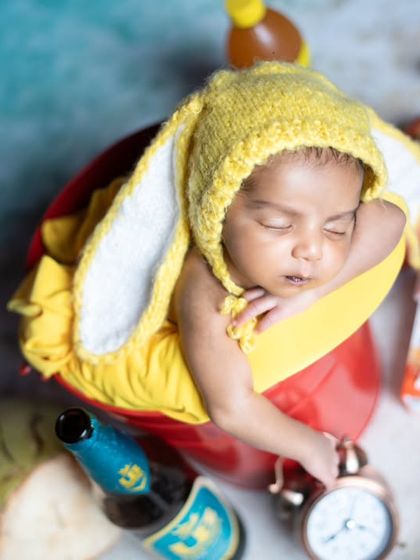 A close-up of a newborn bunny, surrounded by coconuts and beer bottles for a cheeky beach vibe.