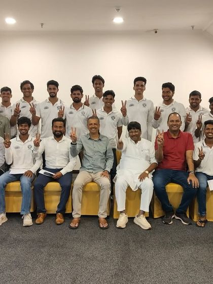 The team and officials celebrate their promotion with a victory sign, marking a proud moment in our club's journey in the Kanga Cricket League.