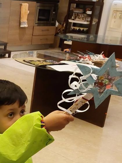 A young wizard casting a spell with his handmade wishing wand. Crafting is not just about making things; it's about sparking imagination.