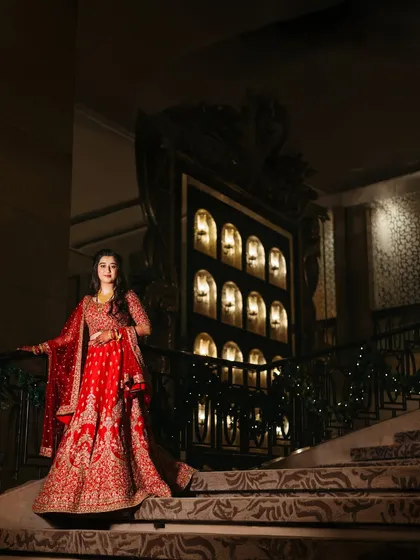 Sanhita posing on the iconic St. Regis staircase. A timeless frame for a timeless bride, showcasing her regal reception look.
