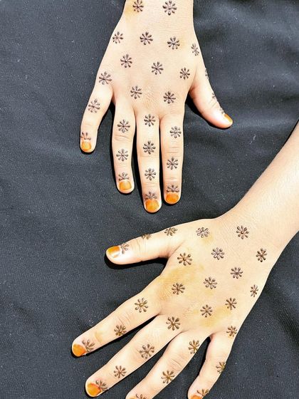 A playful "daisy" design with small, simple flowers scattered all over the hands.