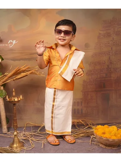 Adding a little bit of swag with sunglasses. This little boy is rocking his traditional look for his birthday shoot.