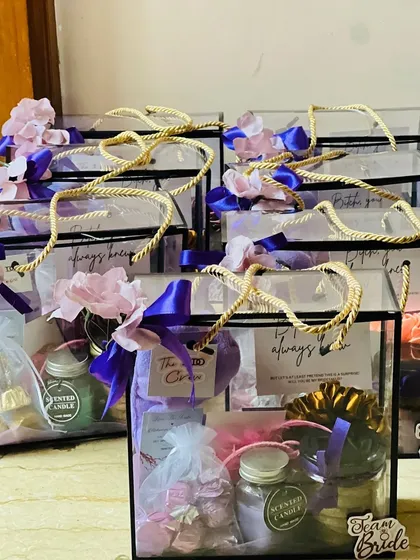 I love creating these bridesmaid proposal hampers for the 'Team Bride'. These modern, transparent boxes are filled with personalized goodies like scented candles, cookies, and custom notes to make your friends feel cherished.