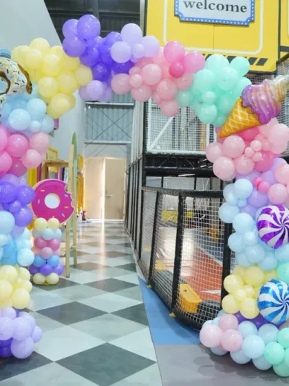 Another look at the candy-themed balloon arch, featuring donut and ice cream mylar balloons. These details make our themed decorations stand out.