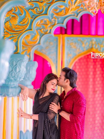 A romantic kiss against the vibrant backdrop of our Jaipuri palace set, with the bright colors making the moment pop.