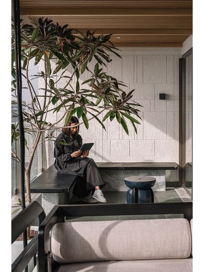 A quiet moment on the master bedroom deck. We designed this built-in bench to be a private space for reflection, surrounded by greenery and the open sky. It’s these small, personal nooks that transform a house into a home.