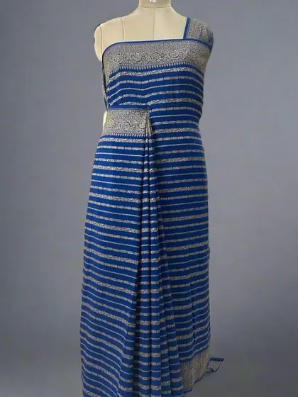 A mannequin draped in a blue pure Banaras crepe saree with silver stripes.