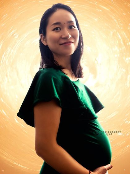 A beautiful backlit portrait creating a radiant glow around the mom-to-be, emphasizing the joy of pregnancy.