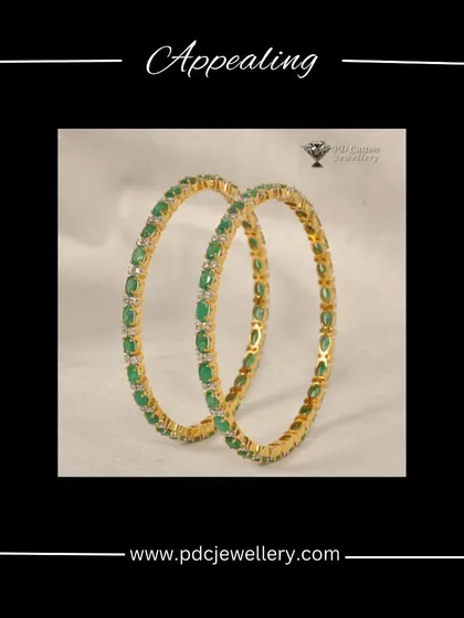 Appealing emerald and diamond bangles in 18kt hallmark gold. The vibrant green of the emeralds provides a beautiful contrast to the sparkling diamonds.