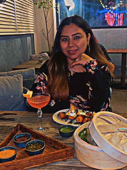 A candid shot of me enjoying a meal at Dutchman's Port, surrounded by their unique decor and a delicious spread of food.