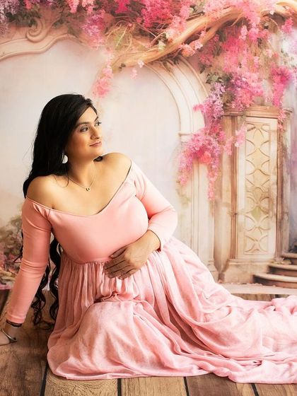 Looking away in a moment of reflection. This pose adds a sense of wonder and contemplation to the maternity gallery.