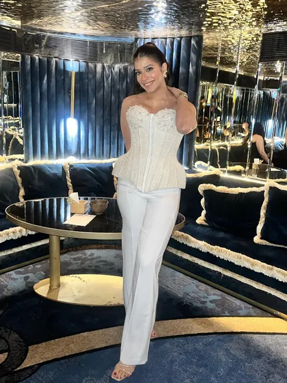The full look, showing how the makeup and hair come together with her stylish outfit for a perfect anniversary celebration.