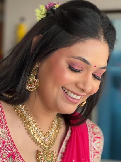 A close-up of the pink-toned makeup, with the bride's eyes closed to showcase the beautiful liner and eyeshadow. The look is soft, romantic, and full of joy.