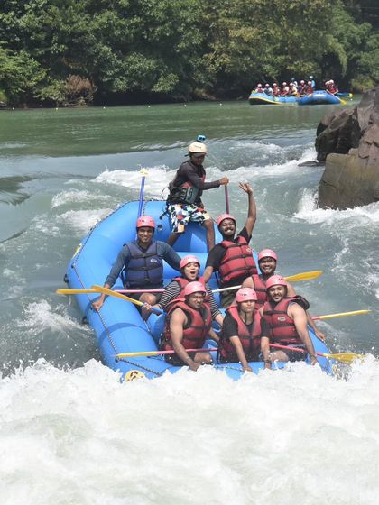A team celebrating after successfully navigating a challenging rapid. The sense of accomplishment is a huge part of the Dandeli adventure.