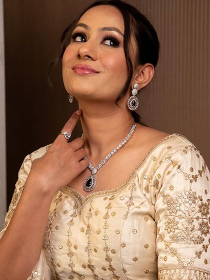 This elegant diamond and sapphire necklace set is another beautiful option from our rental collection. It adds a touch of timeless sophistication to this embroidered blouse.