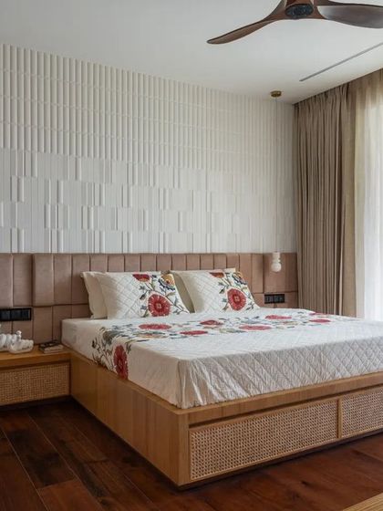 For the parents' bedroom, I aimed for a balance of warmth and artistic expression. A 3D patterned tile wall serves as a unique headboard, while the bed frame and side tables feature natural wood and cane for an earthy, tactile quality.