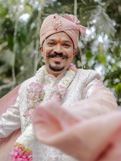 The groom's happiness shines through in this baraat portrait.