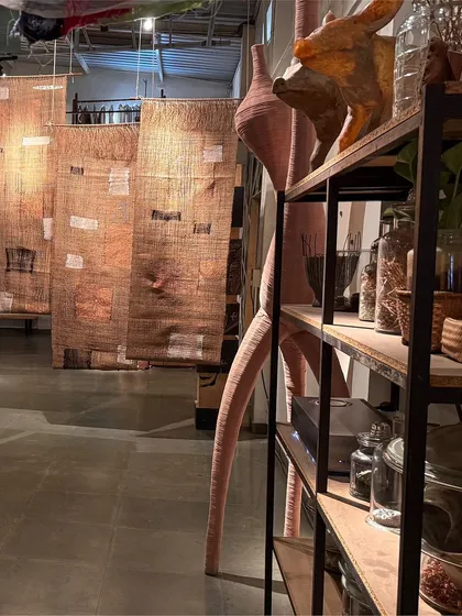 A view of our studio during the 'Cu+Fibers' exhibition. Hand-woven panels of jute and upcycled cotton hang alongside other sculptural forms, showcasing the aggregate of small discoveries made during our creative process.