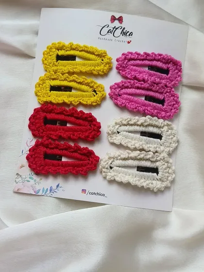 A set of four pairs of our crochet barrettes in yellow, pink, red, and cream. A great starter set to match many different outfits.