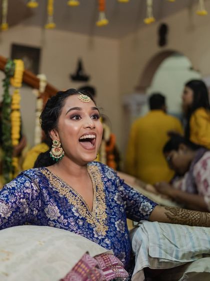 The bride's exuberant joy during her Mehendi ceremony, her unique outfit a reflection of her personality.