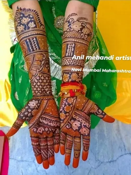 A vibrant and traditional full-hand mehandi. The design is filled with floral motifs and checkerboard patterns, and the bright orange stain on the fingertips shows the quality of my organic henna.