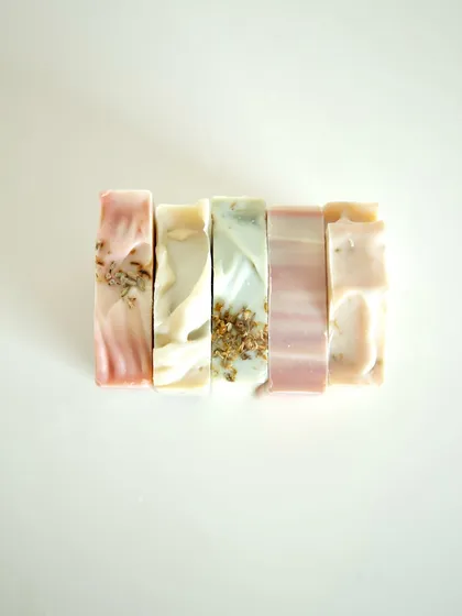 A stack of some of my favorite creations, each with its own story and scent. From the floral notes of Flower Market to the earthy calm of Lavender Patchouli, there's a bar for every mood.