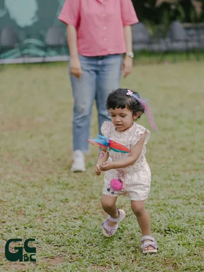 A little one completely absorbed in the magic of a spinning pinwheel. These simple moments of childhood wonder are beautiful to witness.