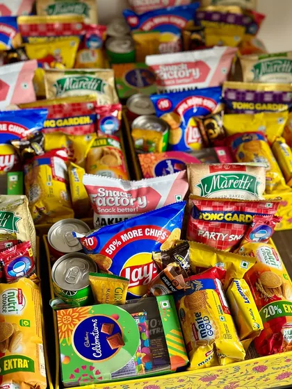 A close-up of the snack-filled room hampers. I include a mix of everyone's favorites like Lays, Nutrichoice, and Cadbury Celebrations to bring back those happy childhood memories.