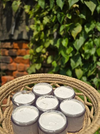 Holding up a basket of my freshly handmade scrub. I take pride in creating products that deliver real benefits, from deep cleaning to tan removal.
