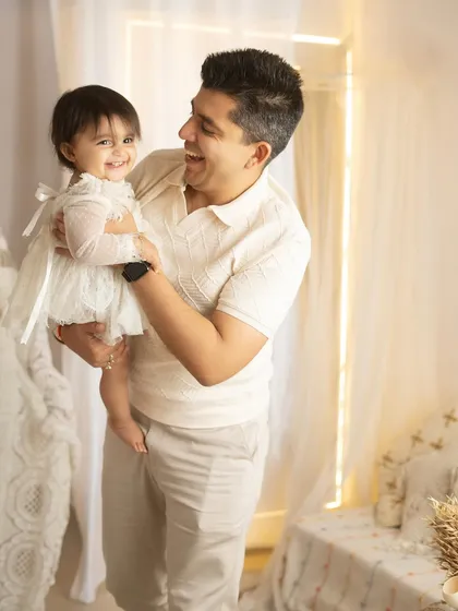 A father's love, reflected in his joyful smile as he holds his daughter. These one-on-one moments are a precious part of every family session.