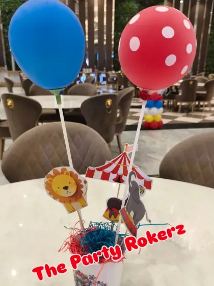 A cute and simple table centerpiece for the carnival party, featuring balloons and cutouts of circus animals.
