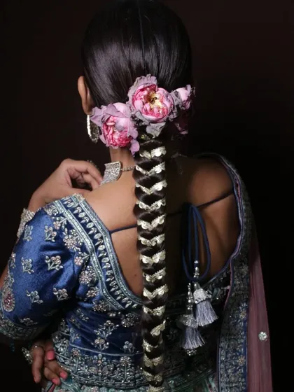 My courses go beyond just makeup. Here is an example of an intricate bridal braid with floral accessories, showcasing the advanced hairstyling techniques we teach to make you a complete beauty professional.