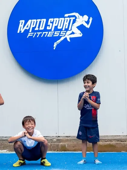 Training should be effective, but it should also be fun. Here, some of our young athletes share a lighthearted moment at our Jayamahal facility. I foster an environment where kids can build friendships and enjoy the process of getting stronger together.