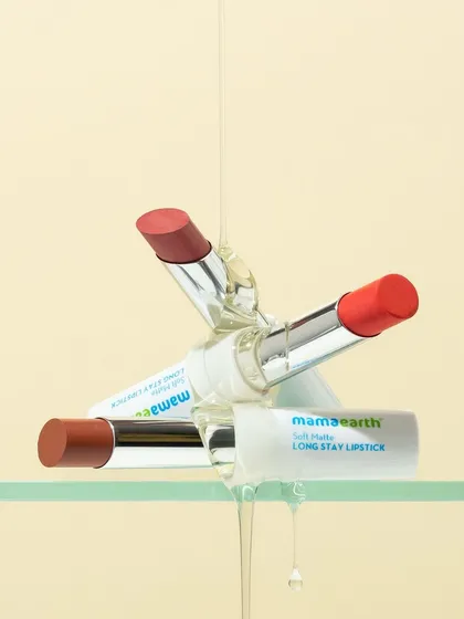 A playful stack of lipsticks gets an upgrade with a drizzle of clear, glossy texture. This shot is all about combining different elements, color, product, and texture, to create something visually exciting.