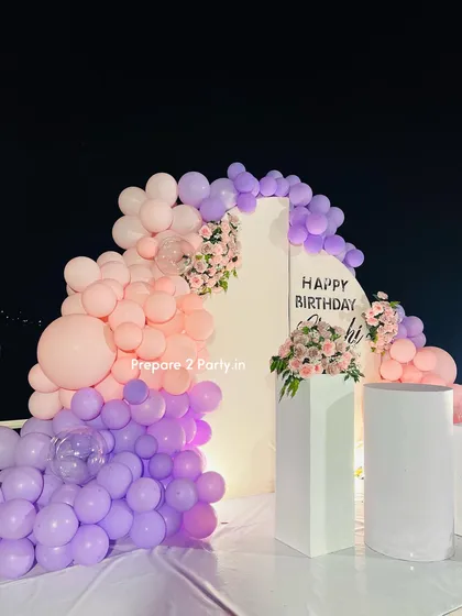 This image shows the scale of our pastel birthday balloon garland against the custom backdrop. We use a variety of balloon sizes to create an organic, flowing shape that beautifully frames the event space.